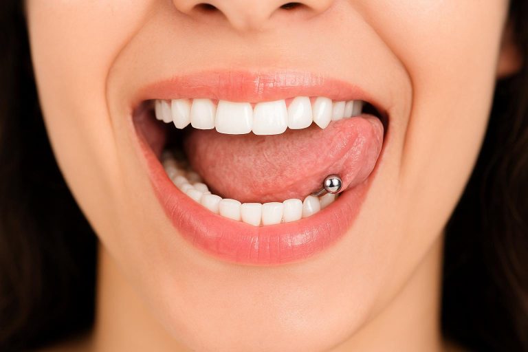 Close-up of a mouth with a tongue piercing and white teeth